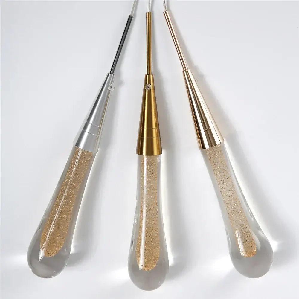Three decorbites crystal glass led pendant lights with gold teardrop bodies and metallic stems in silver gold and rose gold finishes