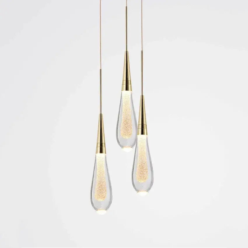 Elegant gold pendant lights with teardrop decorbites crystal glass led shades filled with glowing golden particles for dining room