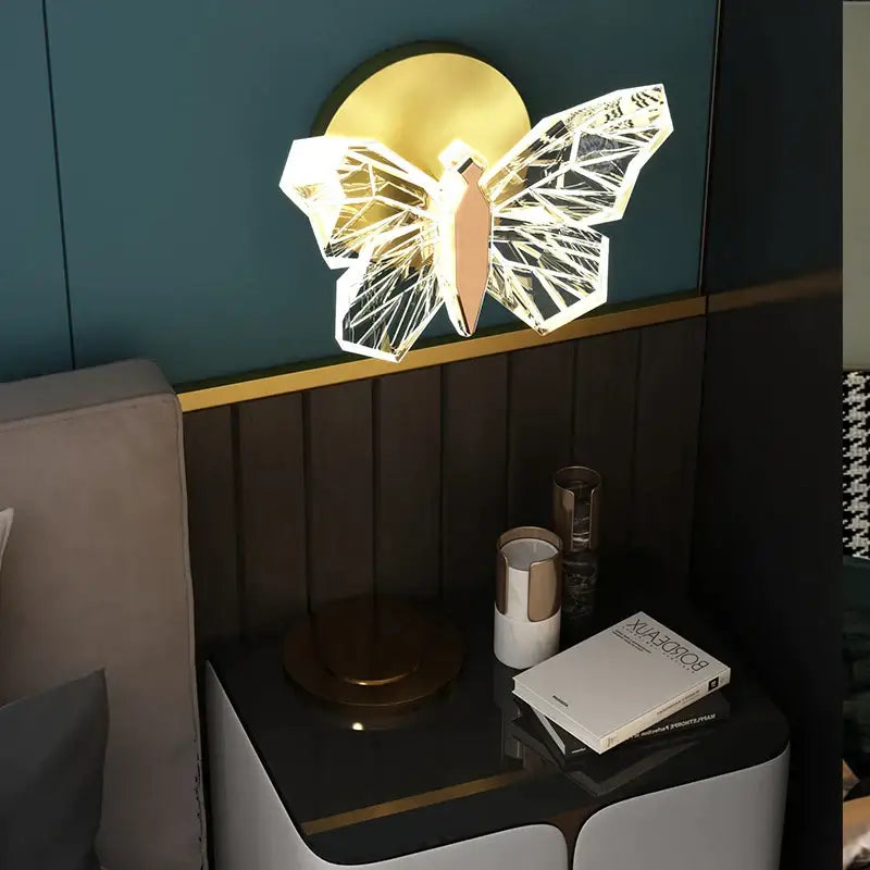 A modern decorbites butterfly chandelier wall sconce with geometric translucent design and gold-toned accents