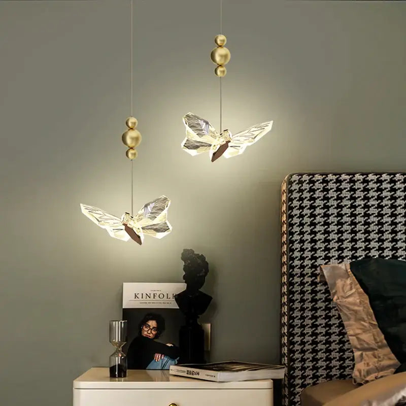 Two elegant translucent crystal decorbites butterfly chandelier pendant lights with gold-toned spherical fixtures