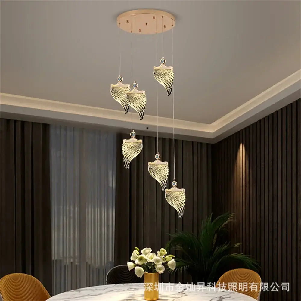 Elegant golden shell acrylic chandelier with gold-toned leaf pendant lights and intricate mesh detailing for living spaces