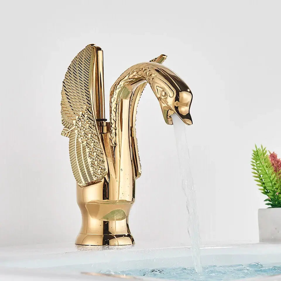 Elegant golden swan faucet with detailed feathered wings and polished finish for bathroom hot and cold mixer tap