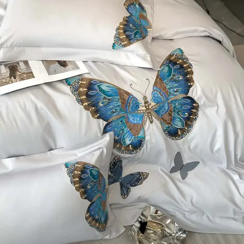 White bedding set with intricate blue and gold decorbites butterfly embroidery and shimmering details for bedroom decor