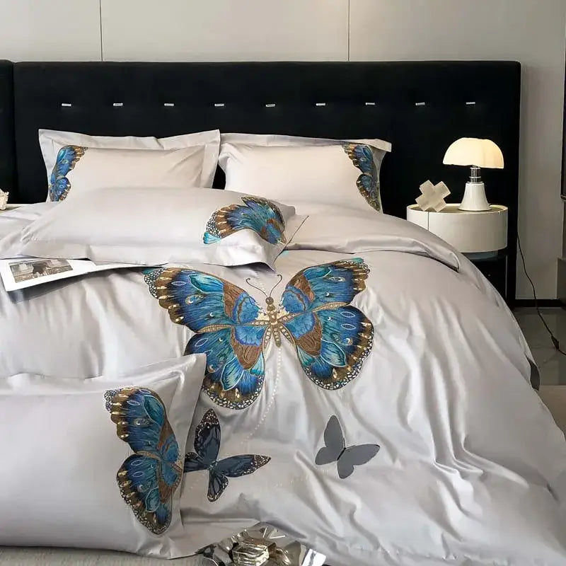 Elegant white satin bedding set with decorbites butterfly embroidery in blue and gold for refined bedroom linens