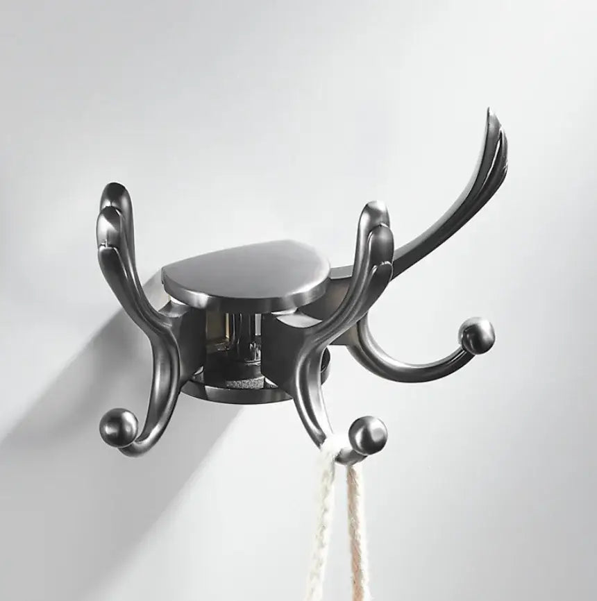 Black metal coat rack with ornate curved arms and spherical finials featured as elegant green gold single hook