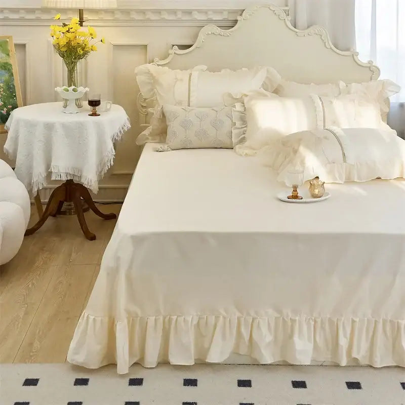 Cream-colored ruffled bed skirt with delicate pleats in decorbites elegant heart satin bedding set with floral lace embroidery