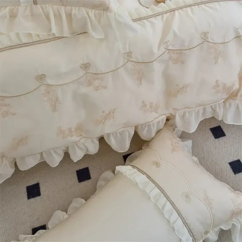 Cream-colored ruffled bed canopy with beige floral lace embroidery and heart-shaped buttons from decorbites elegant heart bedding set