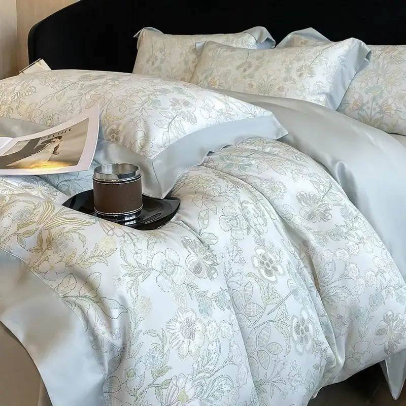 Light blue satin duvet cover with delicate gray and gold floral embroidery in decorbites eucalyptus fiber bedding set