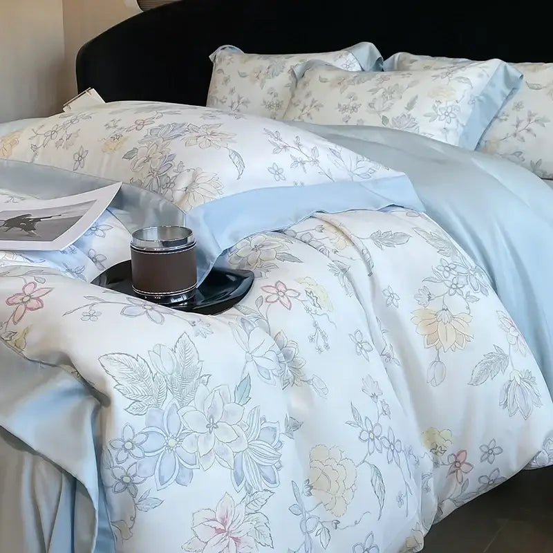 Elegant ivory floral eucalyptus fiber bedding set with soft blue satin fabric and pastel blossoms for bedroom decorbites