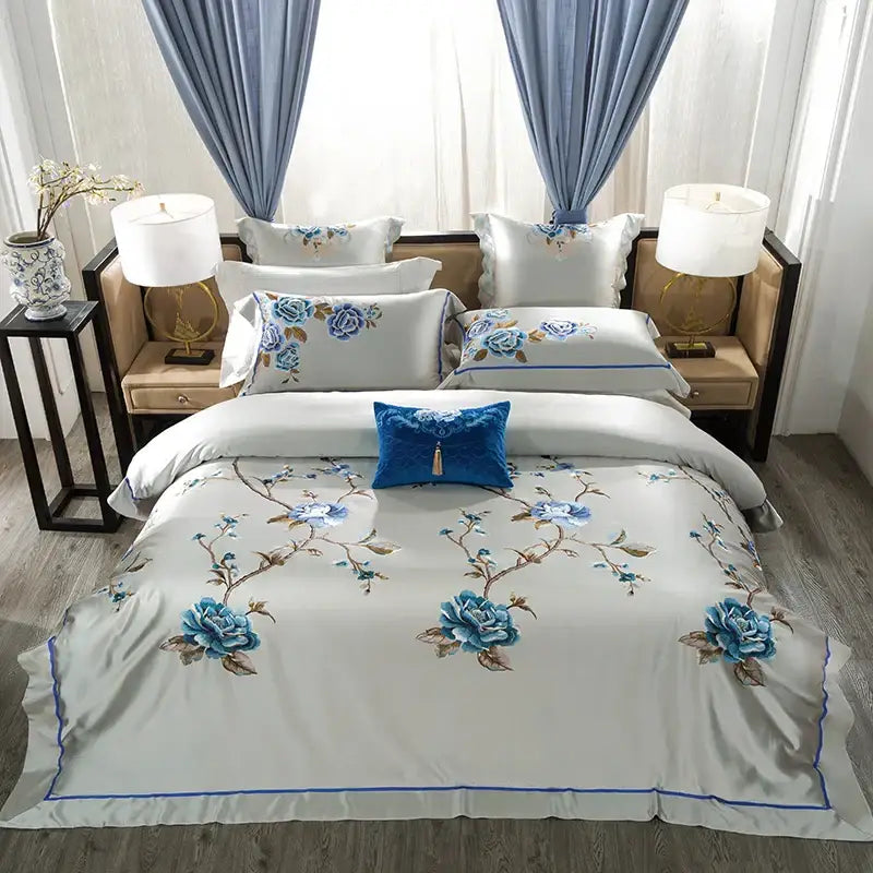 Elegant ivory and royal blue 200s embroidery egyptian cotton bedding set with intricate floral embroidery and accent pillows