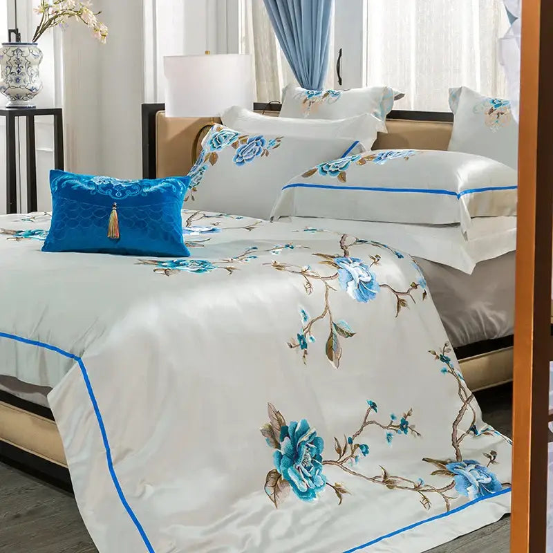 Elegant ivory and royal blue bedding set with white satin duvet cover featuring 200s embroidery egyptian cotton design