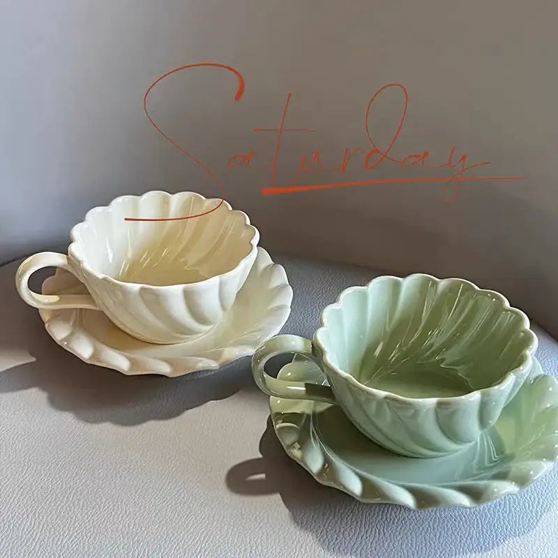 Elegant lace ceramic coffee cup and saucer set in white and mint green with scalloped shell design for dining room