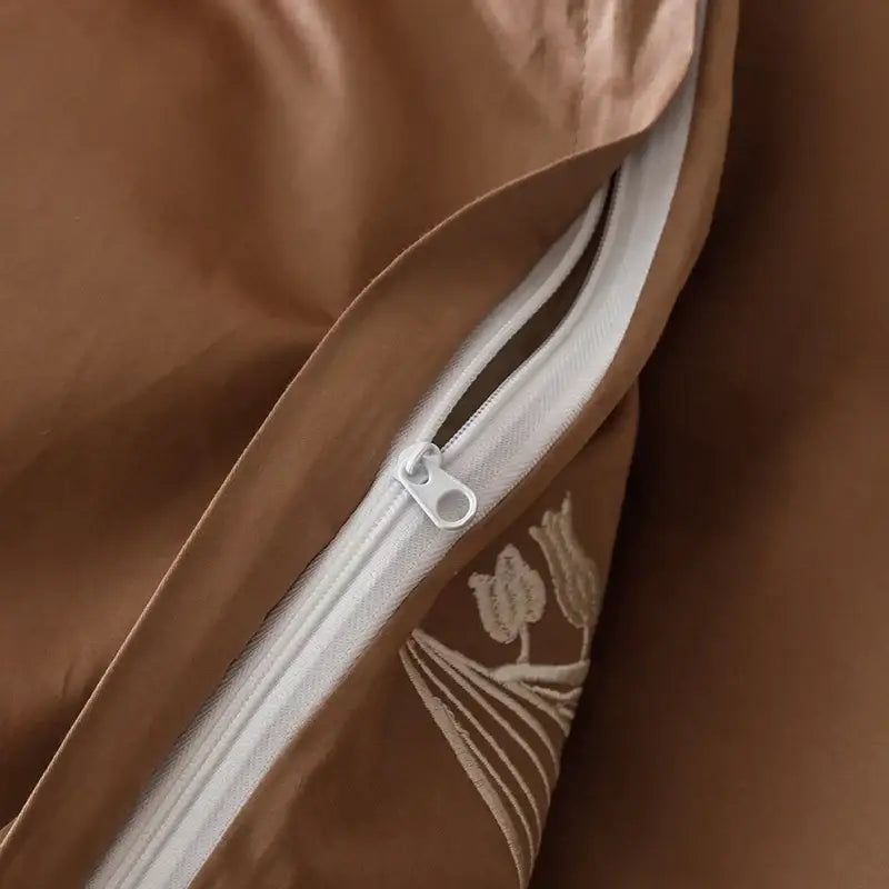 Brown satin duvet cover with subtle embroidered floral design and white zipper in decorbites elegant lily cotton bedding set