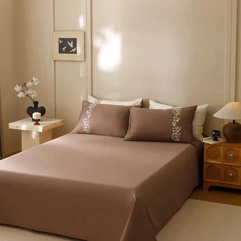 Brown satin cotton bedding set with delicate white floral embroidery on pillowcases from decorbites elegant lily collection
