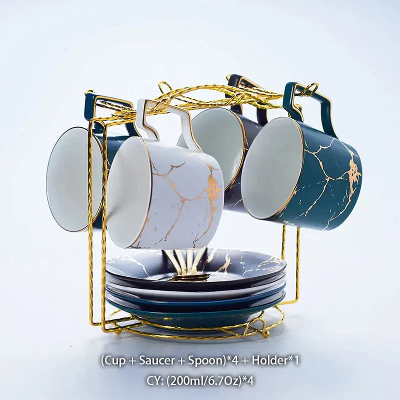 Elegant marble ceramic tea set with gold accents and crackle glaze in white and deep teal on a golden wire rack