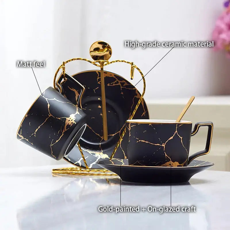 Elegant black marble ceramic tea set with gold veining and matching golden stand for sophisticated dining room use