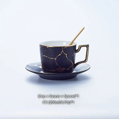 Elegant black marble ceramic tea set cup with gold crackle design and matching saucer with wooden spoon
