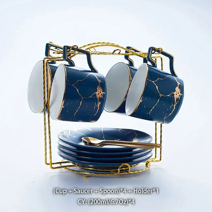 Set of four navy blue marble ceramic tea set cups with gold crackle glaze and saucers on a gold metal rack