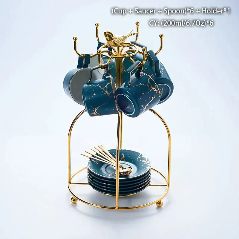 Set of six teal marble ceramic tea cups with gold leaf accents on matching saucers and spoons in gold stand
