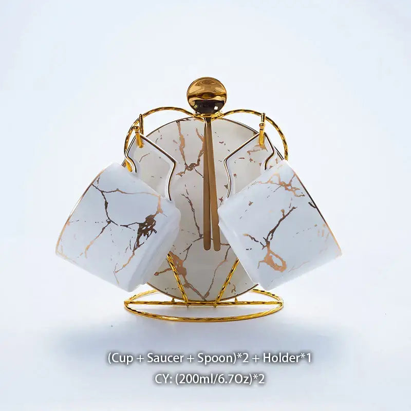 Elegant marble ceramic tea set with white marble-patterned cups gold veining matching saucers on golden stand