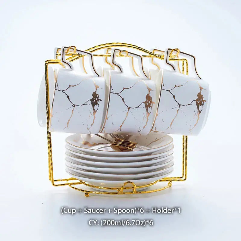 Elegant marble ceramic tea set featuring white ceramic mugs with gold marble crackle design and gold rims in a holder