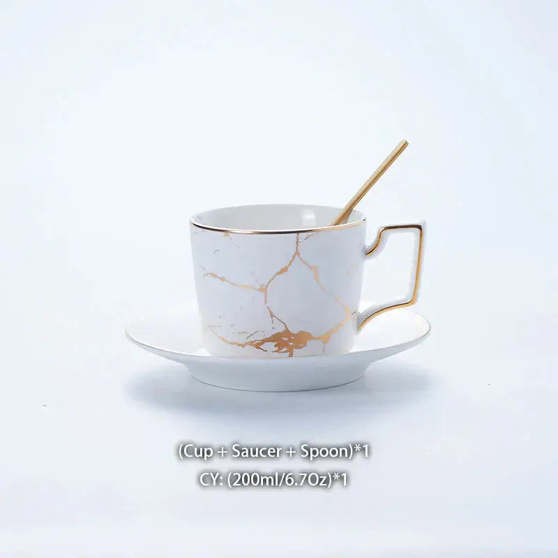 Elegant marble ceramic tea set white cup with gold crackle design and sleek gold rimmed handle on matching saucer