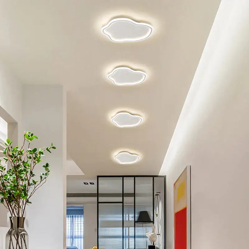 Four white cloud-shaped led ceiling lights with glowing edges elegant master bedroom chandelier decorbites elegant master