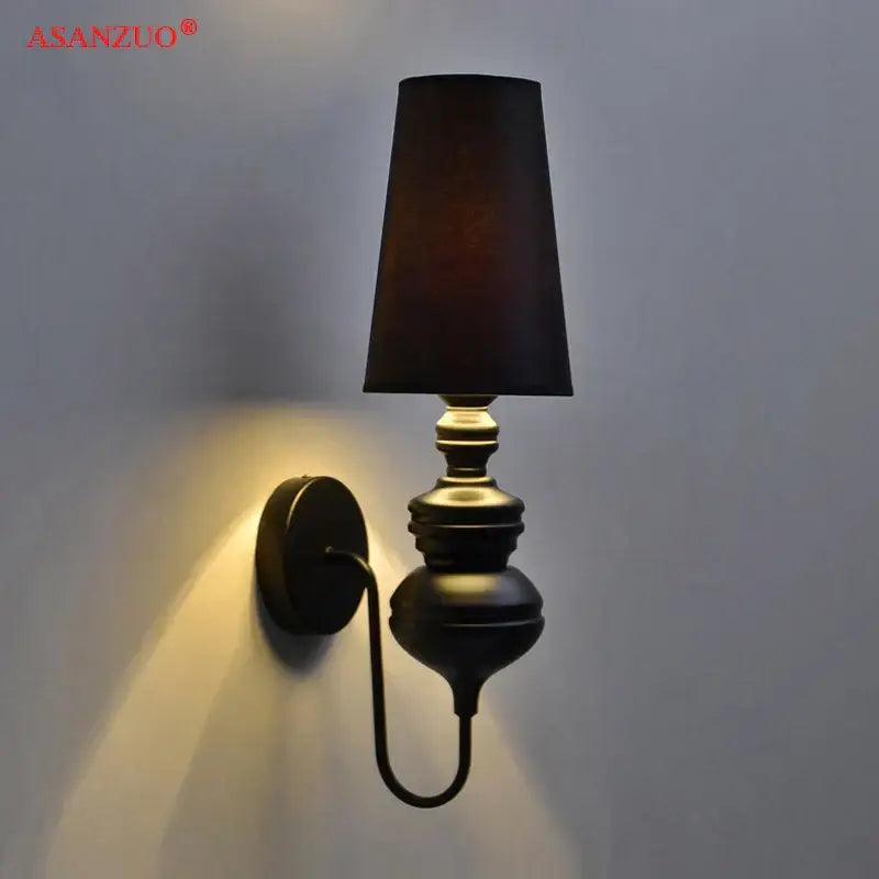 Black matte-finished decorbites guards wall lamps with tapered fabric shade and ornate curved arm for elegant bedroom wall lamps