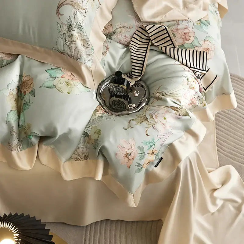 Elegant mint floral eucalyptus fiber bedding set in light blue satin with cream ruffled edges and matching pillowcases