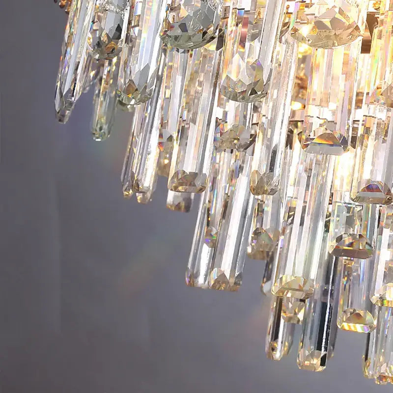 Elegant multi tiered pendant lights with clear crystal prisms and golden accents for dining room decorbites elegant room lights