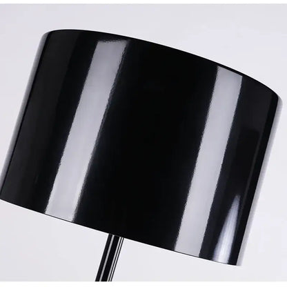 Black glossy cylindrical lampshade on decorbites elegant mushroom floor lamp providing warm glow for living room decor
