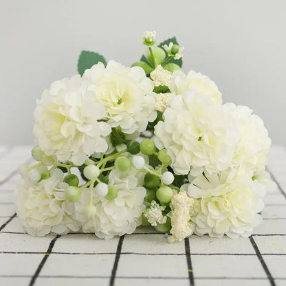 Delicate artificial white hydrangeas with green berries and leaves in an elegant pink decorbites daisy bouquet for living room decor