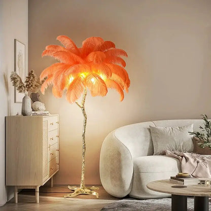 A vibrant orange elegant feather floor lamp with a golden metallic base designed as an ornamental tree decorbites elegant feather