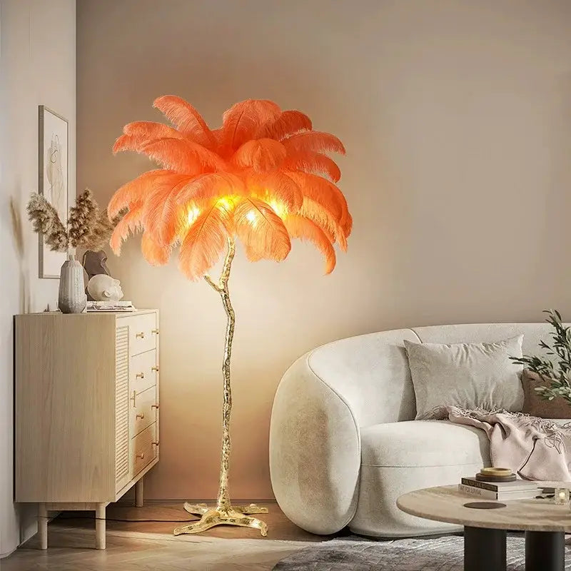 A vibrant orange elegant feather floor lamp with a golden metallic base designed as an ornamental tree decorbites elegant feather