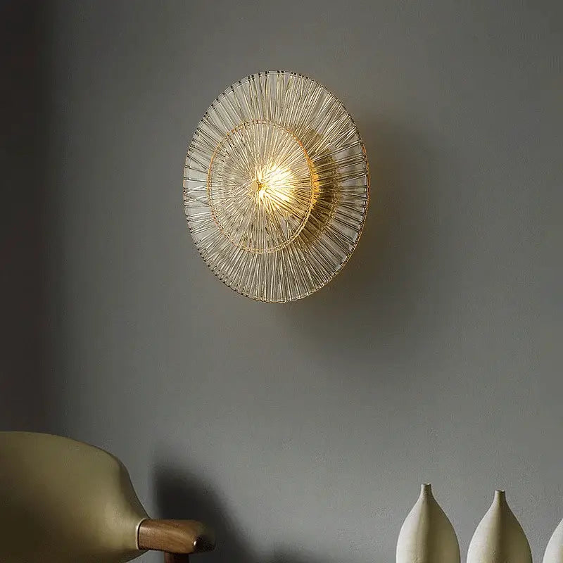 Elegant ribbed glass wall sconce with translucent circular design and warm golden glow for decorbites elegant glass decor