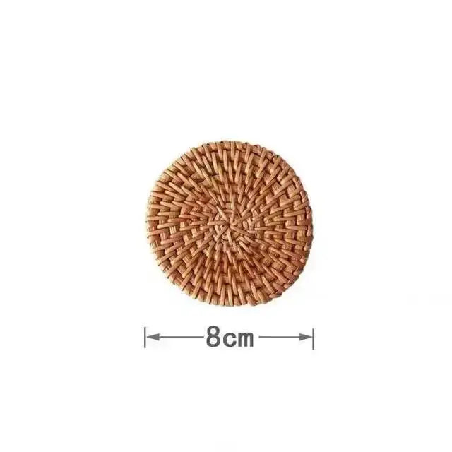 A round 8cm natural brown rattan coaster with a tight pattern paired with an elegant decorbites glass straw cup