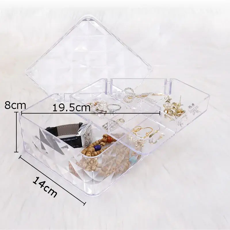 Clear acrylic jewelry boxes with geometric cutouts and multiple compartments for elegant rose gold and silver jewelry