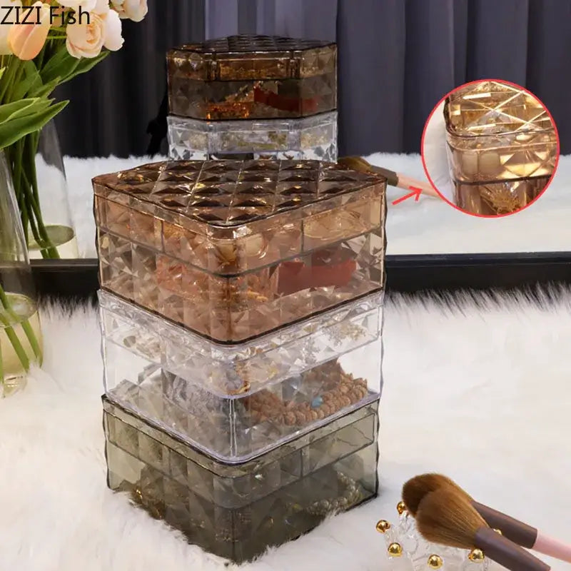 Stacked transparent acrylic jewelry boxes with elegant rose gold and silver tones featuring a quilted faceted design