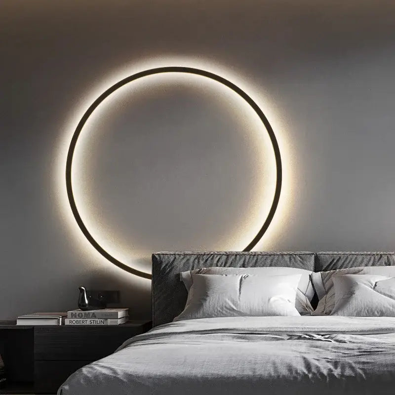Elegant round wall sconces with a sleek black frame and warm glowing illumination for bedroom indoor lighting