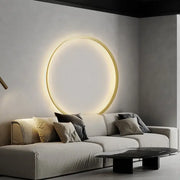 A sleek decorbites elegant round wall sconce with a warm glow and thin gold-toned frame for bedroom lighting
