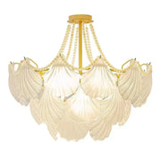 Elegant off-white shell pearl chain chandelier with gold-toned metal frame and crystal pearl chain accents for dining room decorbites