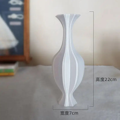 A sleek white ceramic decorbites elegant vase with modern fluted ridges for high-end living room decor
