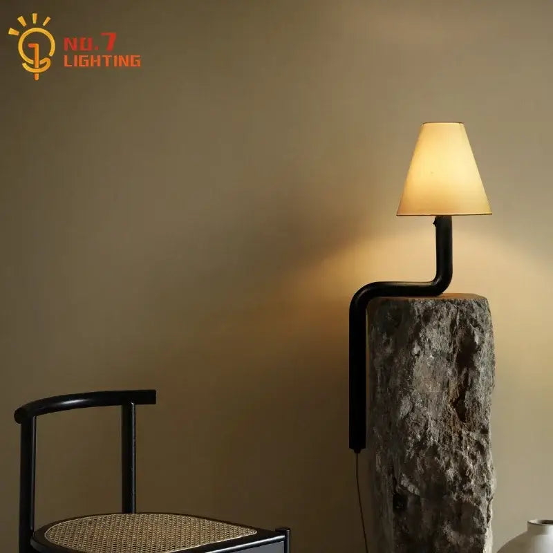 Black metal pipe table lamp with beige conical fabric shade on rough stone base decorbites elegant solid wood design