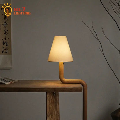 Elegant solid wood table lamp with warm beige fabric shade and curved wooden base for bedroom decorbites elegant solid light
