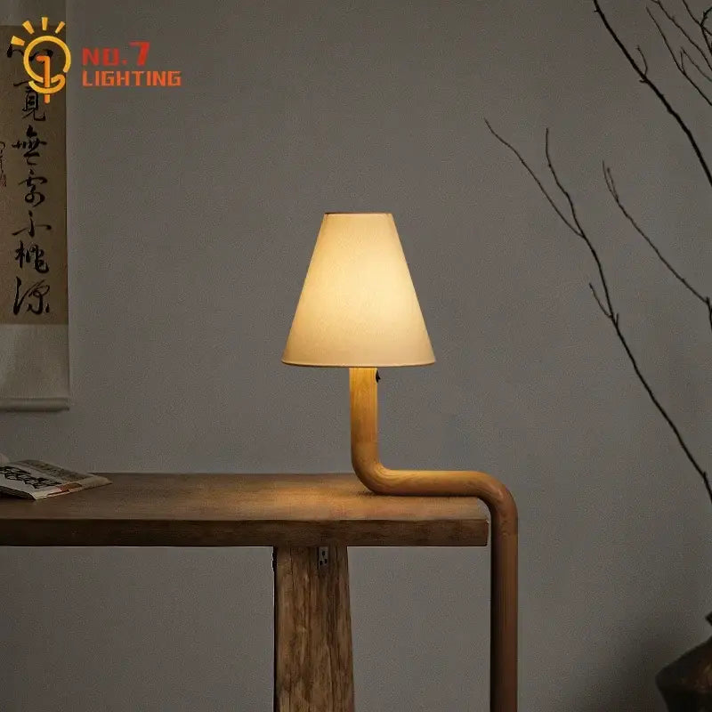 Elegant solid wood table lamp with warm beige fabric shade and curved wooden base for bedroom decorbites elegant solid light
