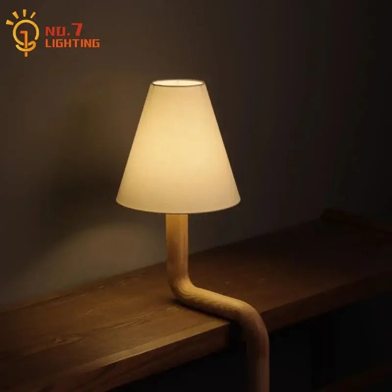 Warm-toned decorbites elegant solid wood table lamp with curved wooden base and off-white fabric shade for bedroom decor