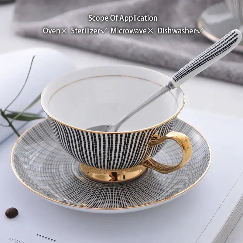 Elegant striped black and white porcelain tea cup set with gold trim and handle paired with matching saucer for dining room