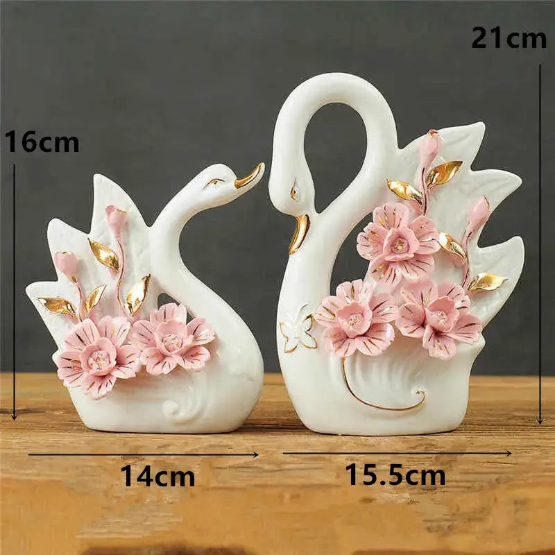 White ceramic swan sculpture figurines with pink flowers and gold leaf accents for elegant swan decorbites decor