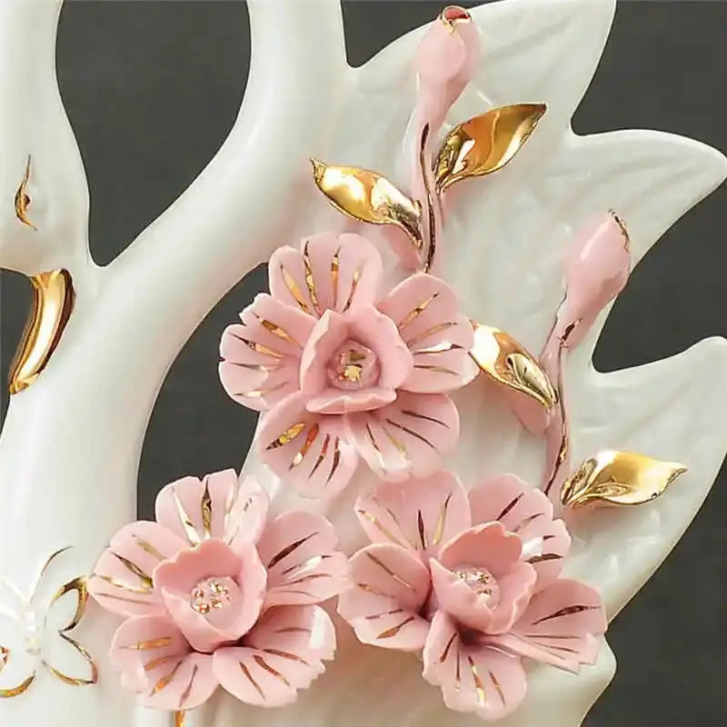Pink ceramic floral arrangement with gold leaf accents and glossy finish in decorbites elegant swan sculpture figurines for living room decor