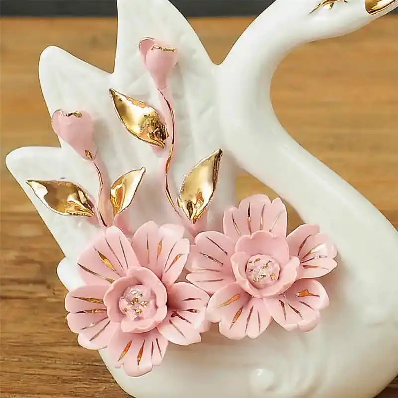 Delicate white ceramic decorbites elegant swan sculpture with pink blossoms and gold leaf accents for living room decor